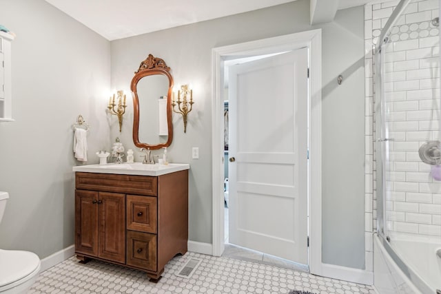 full bathroom with shower / bath combination with glass door, vanity, toilet, and tile patterned flooring