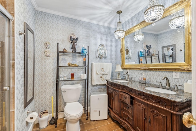 bathroom featuring a chandelier, vanity, toilet, and ornamental molding