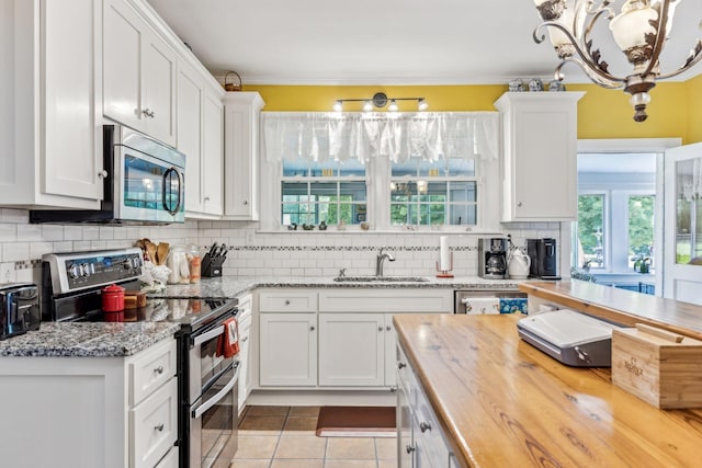 kitchen featuring appliances with stainless steel finishes and white cabinetry