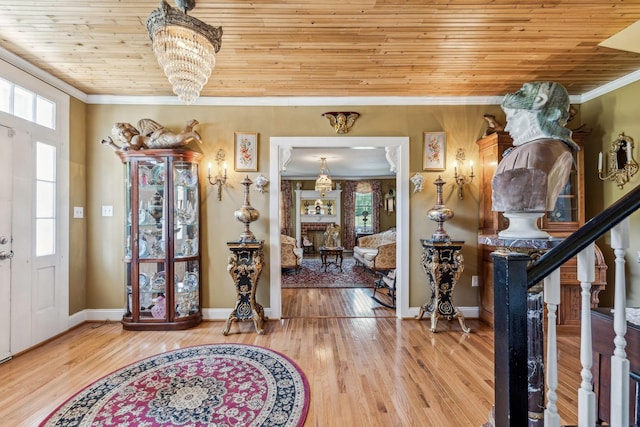 entryway featuring hardwood / wood-style floors, wood ceiling, and ornamental molding