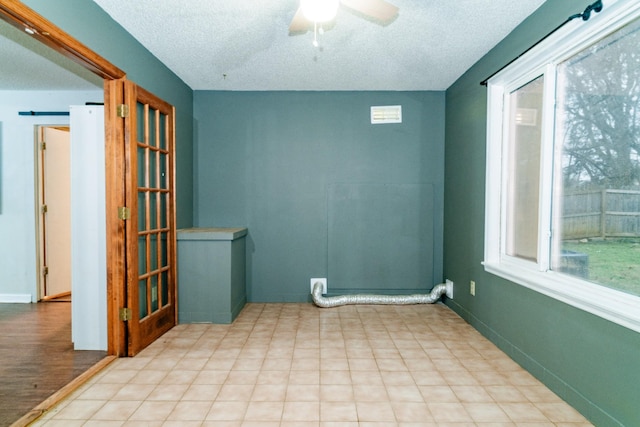 unfurnished room with a textured ceiling and ceiling fan