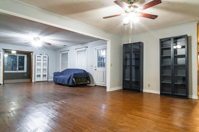 unfurnished bedroom featuring ceiling fan, dark wood-type flooring, and a textured ceiling