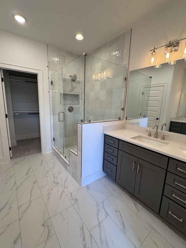 full bathroom featuring marble finish floor, a stall shower, recessed lighting, baseboards, and vanity