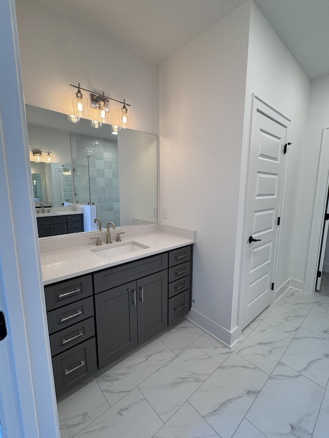 bathroom featuring marble finish floor, vanity, a shower stall, and baseboards