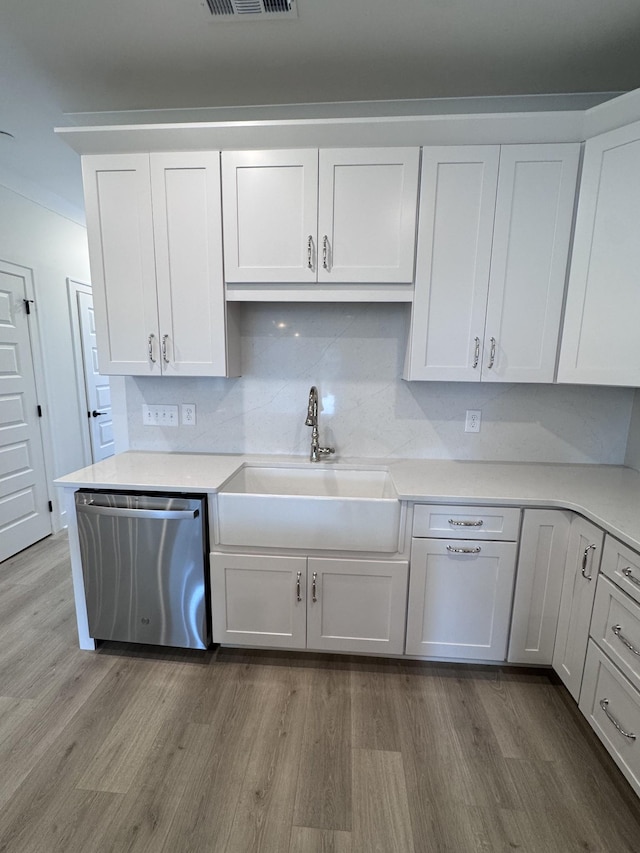 kitchen with dishwasher, wood finished floors, and a sink