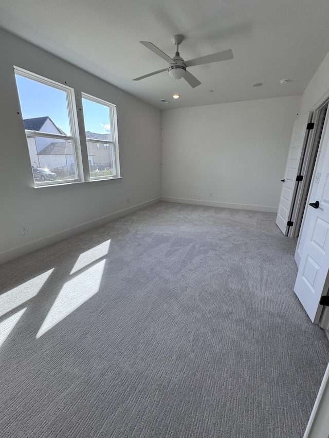 unfurnished bedroom featuring baseboards, ceiling fan, and carpet flooring