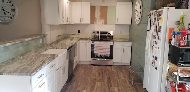 kitchen featuring white cabinets, appliances with stainless steel finishes, dark hardwood / wood-style floors, and light stone countertops