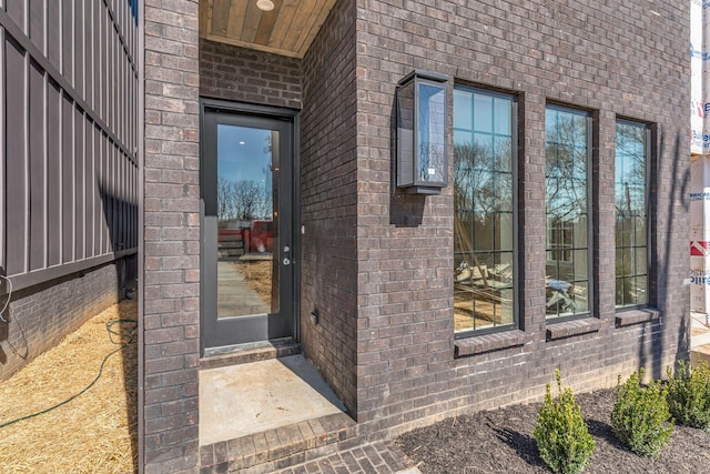 property entrance featuring brick siding