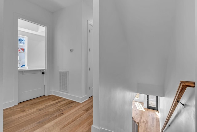 entrance foyer featuring light wood finished floors, visible vents, and baseboards