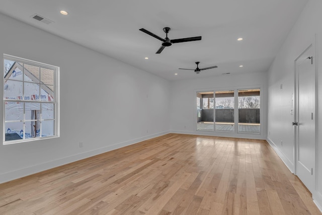 empty room featuring recessed lighting, visible vents, light wood-style floors, a ceiling fan, and baseboards