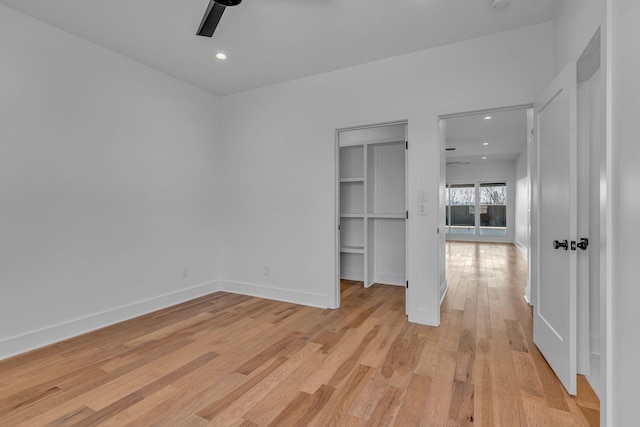 spare room featuring light wood-style flooring, baseboards, ceiling fan, and recessed lighting