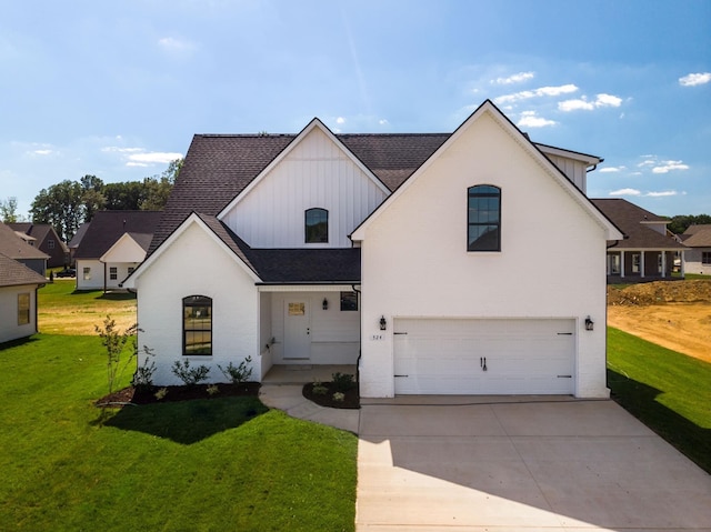 view of front of house with a front yard and a garage