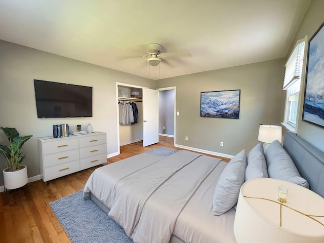 bedroom featuring ceiling fan, a closet, and hardwood / wood-style flooring