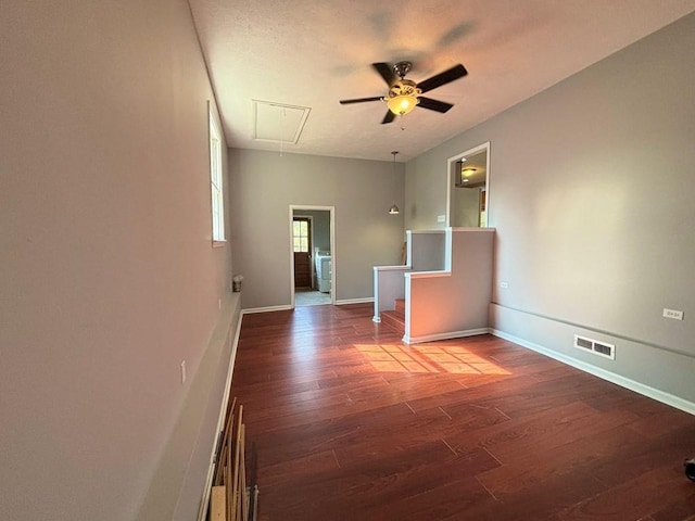 empty room with ceiling fan and dark hardwood / wood-style flooring