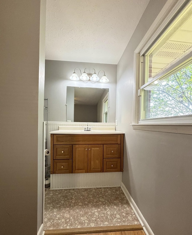 bathroom with vanity and a textured ceiling