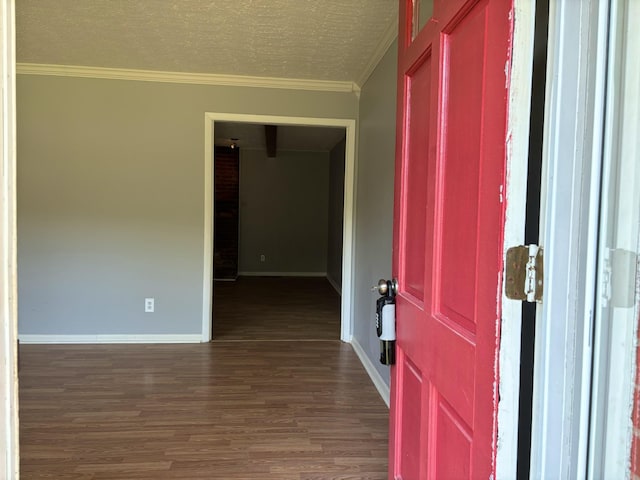 foyer featuring a textured ceiling, dark hardwood / wood-style floors, and ornamental molding