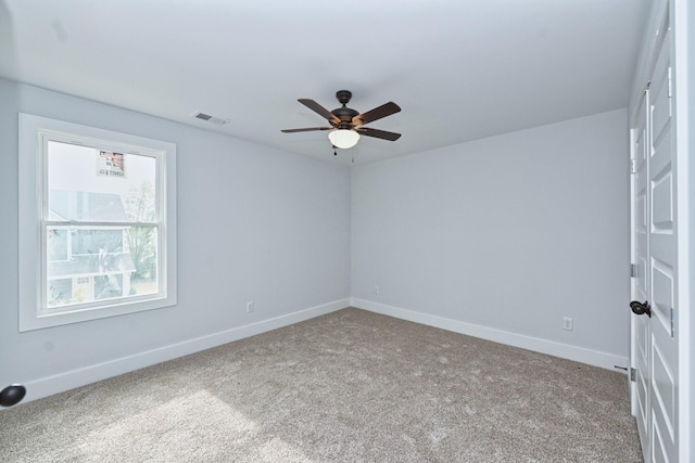 unfurnished room featuring ceiling fan and carpet floors