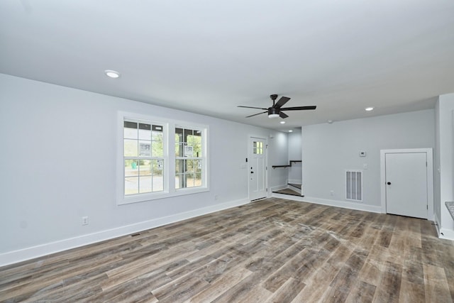 unfurnished living room featuring ceiling fan and wood-type flooring