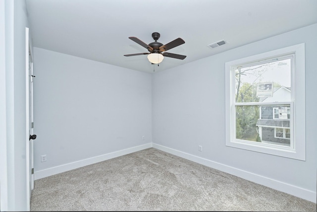 carpeted spare room featuring ceiling fan