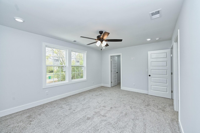 unfurnished bedroom featuring ceiling fan, light carpet, and a closet