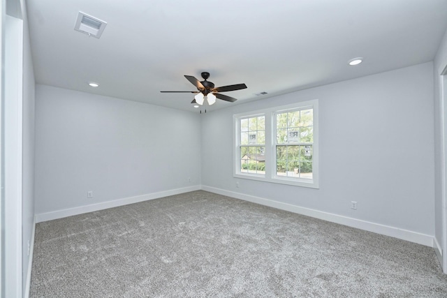 carpeted spare room featuring ceiling fan