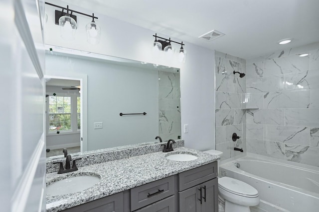 full bathroom with shower / bathing tub combination, vanity, ceiling fan, and toilet