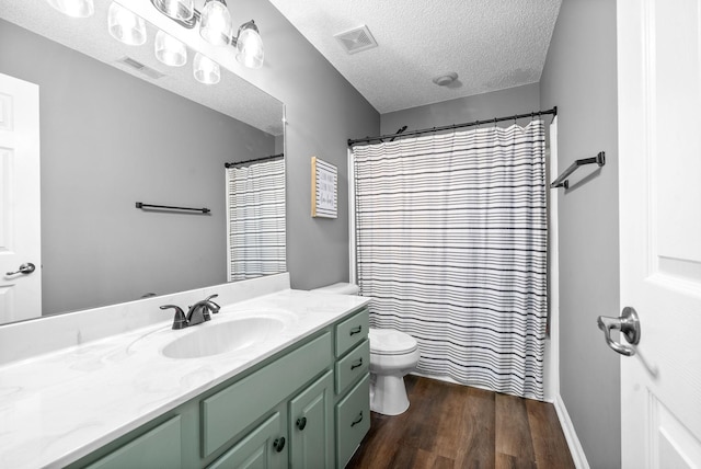 bathroom with a shower with curtain, a textured ceiling, toilet, vanity, and hardwood / wood-style flooring