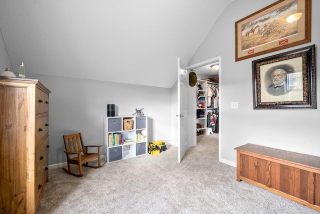 sitting room with light colored carpet and vaulted ceiling