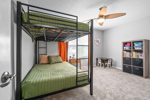 bedroom with a textured ceiling, carpet floors, and ceiling fan