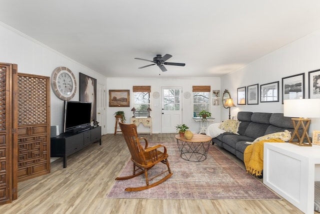 living room with light wood-type flooring and ceiling fan