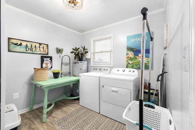 laundry room featuring washer and dryer, wood-type flooring, and crown molding