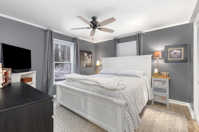 bedroom with ceiling fan, crown molding, and light wood-type flooring