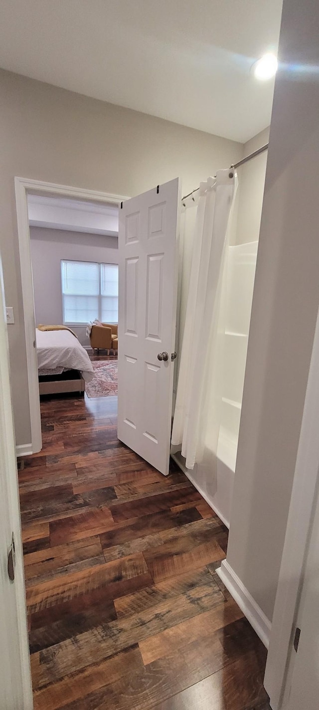 bathroom featuring shower / tub combo and hardwood / wood-style flooring