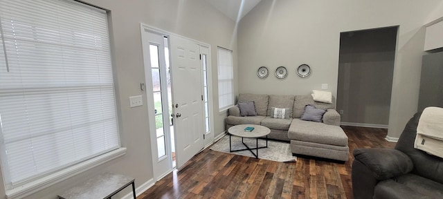 living room with dark wood-type flooring and vaulted ceiling