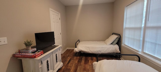 bedroom with dark hardwood / wood-style flooring