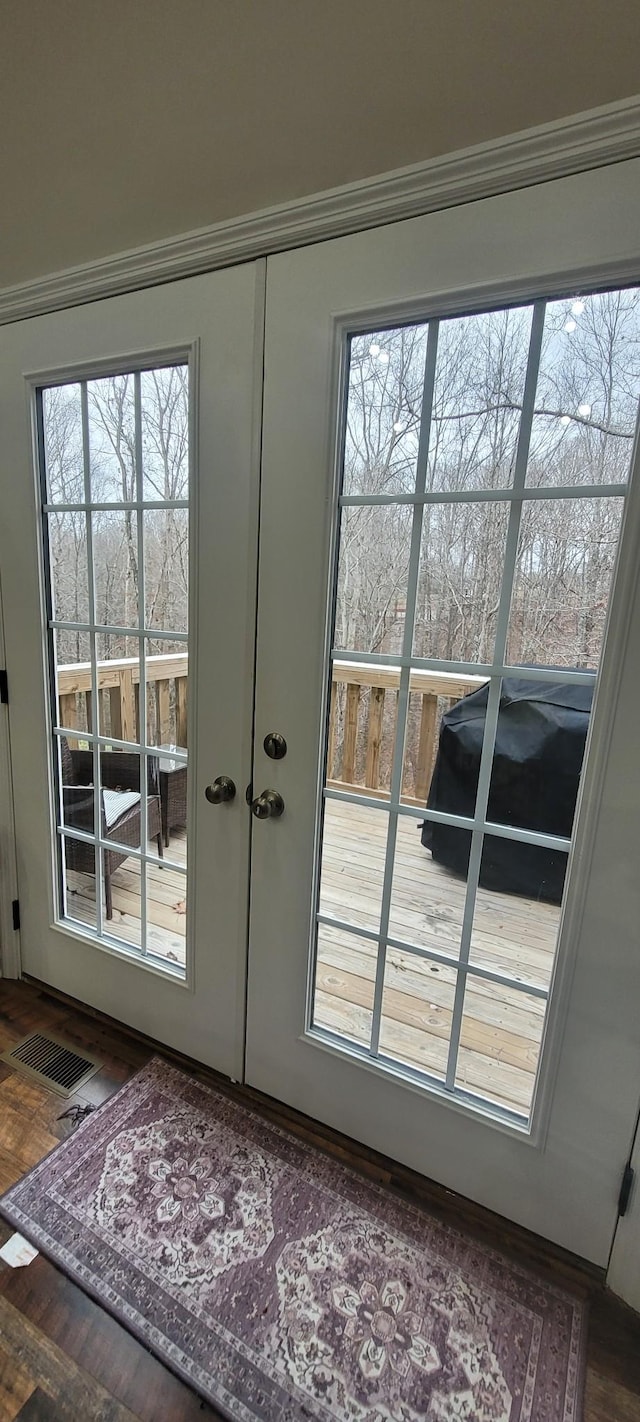 doorway featuring ornamental molding and french doors