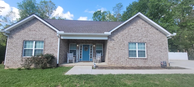 30034 Piper Dr, Bon Aqua, TN 37025 - view of front of home featuring brick siding, a shingled roof, a front yard, and covered porch