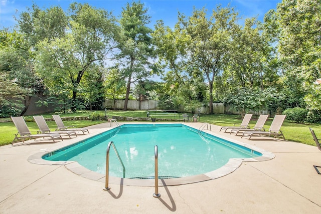 view of swimming pool with a patio area and a yard