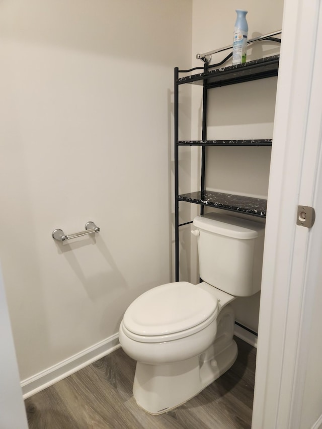 bathroom with toilet and wood-type flooring