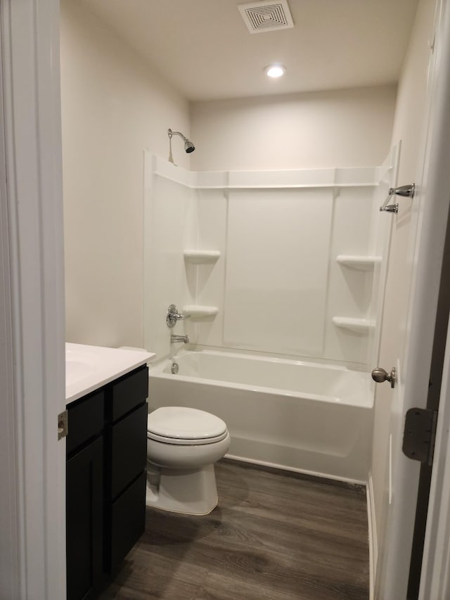 full bathroom featuring toilet, vanity, shower / bathtub combination, and hardwood / wood-style floors