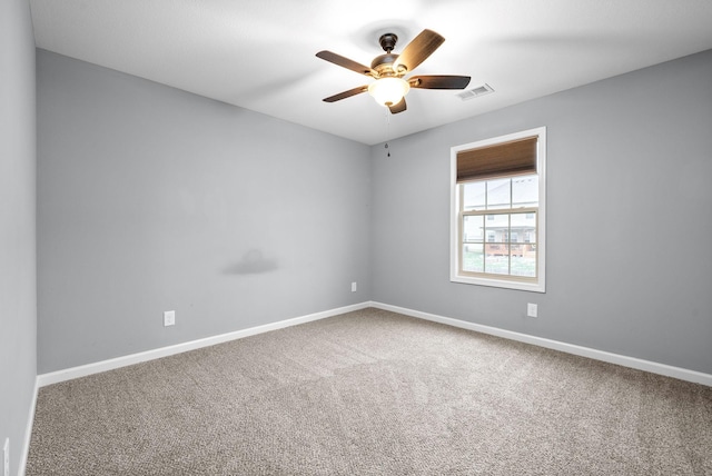 carpeted spare room with ceiling fan