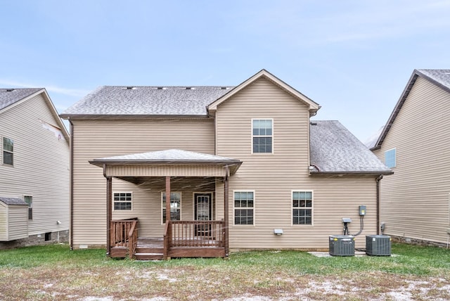 back of house with central AC unit and a porch