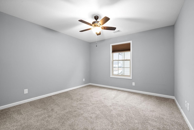 empty room with ceiling fan and carpet floors