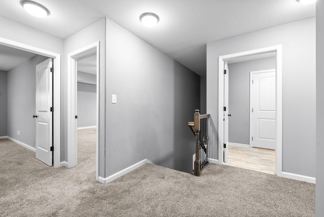 hallway featuring carpet flooring