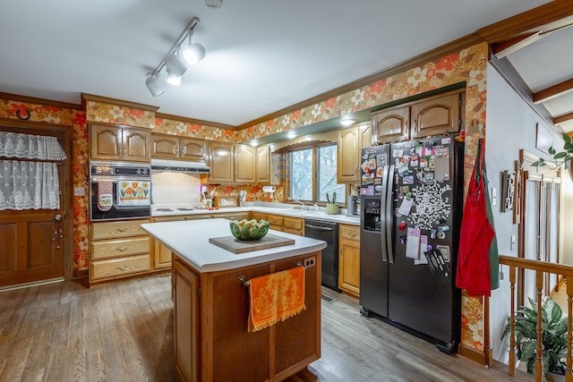 kitchen with a center island, sink, crown molding, hardwood / wood-style floors, and black appliances