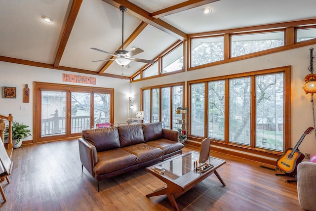 living room with beam ceiling, hardwood / wood-style flooring, plenty of natural light, and ceiling fan