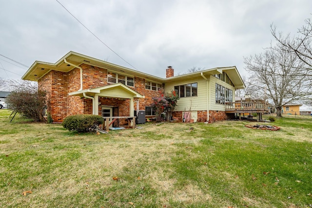 back of house with a lawn, a wooden deck, and central AC unit