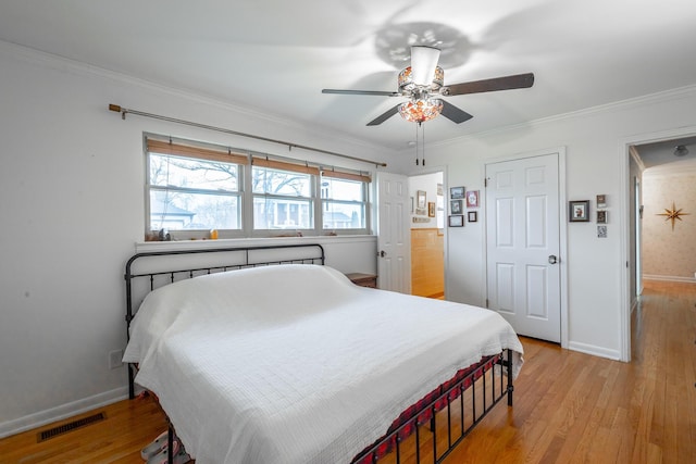 bedroom with light wood-type flooring, ceiling fan, and crown molding