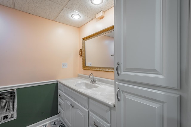 bathroom with a drop ceiling and vanity