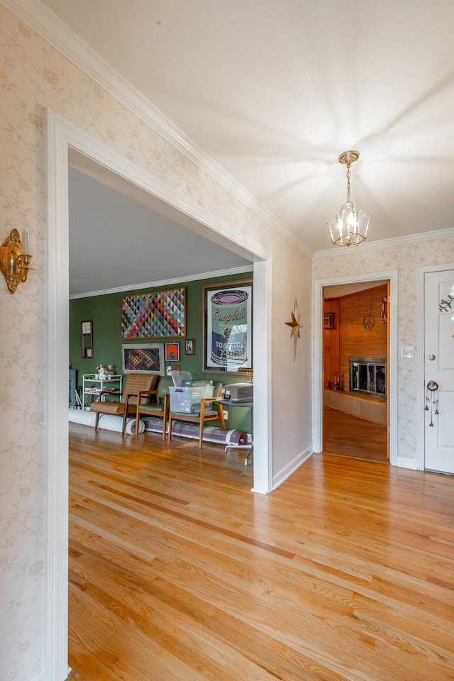 interior space with crown molding, hardwood / wood-style flooring, and an inviting chandelier